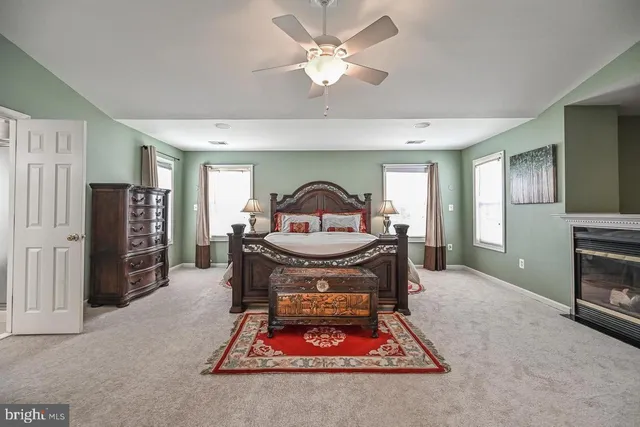 a living room with furniture a table and a fireplace