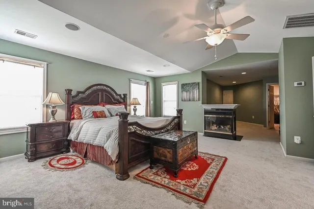 a bedroom with furniture and a fireplace