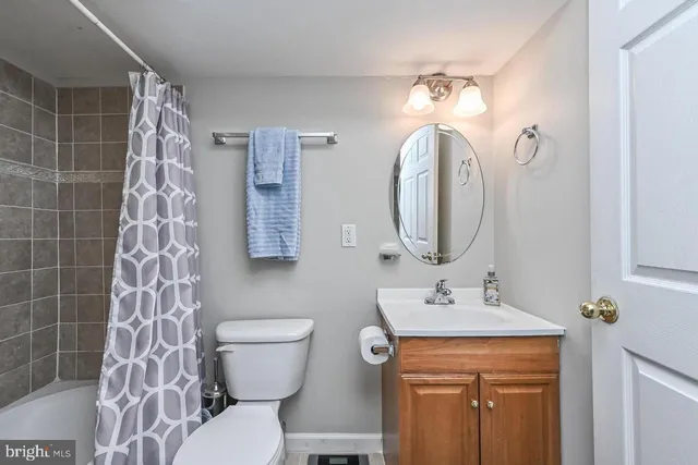 a bathroom with a toilet a sink and a mirror