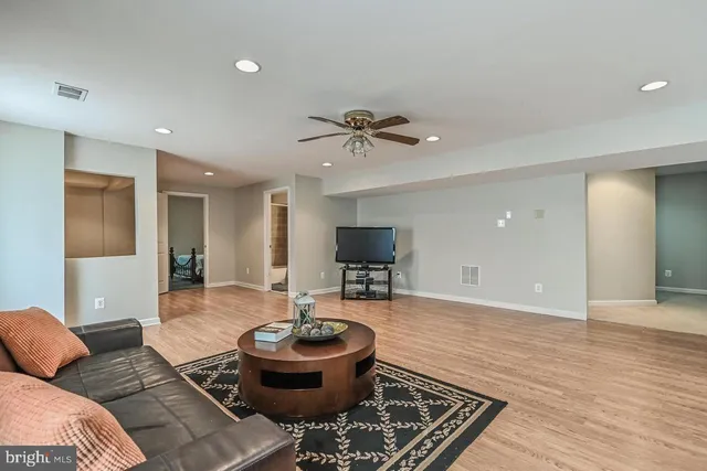 a living room with furniture and a wooden floor