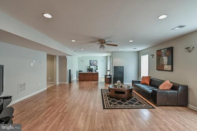 a living room with furniture and a wooden floor