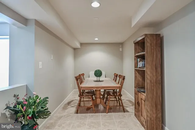 a view of a dining room with a table and chairs