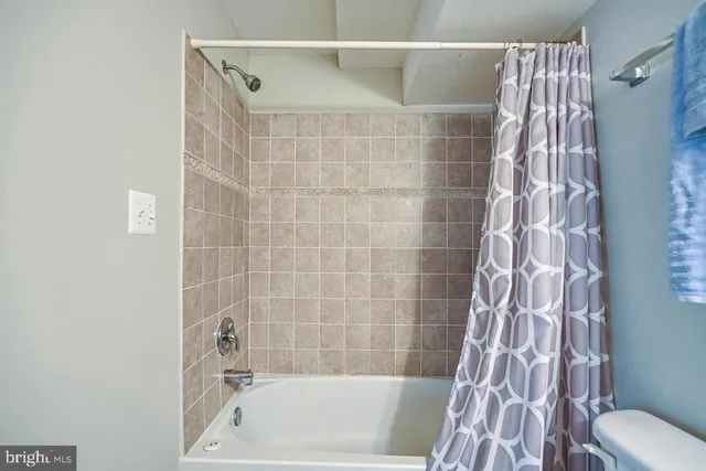 a bathroom with a bathtub and shower