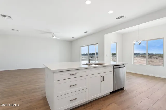 a kitchen with stainless steel appliances white cabinets and a stove top oven