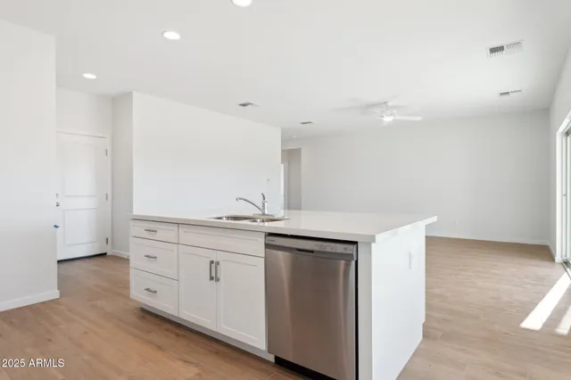 a kitchen with stainless steel appliances granite countertop a stove a microwave and white cabinets