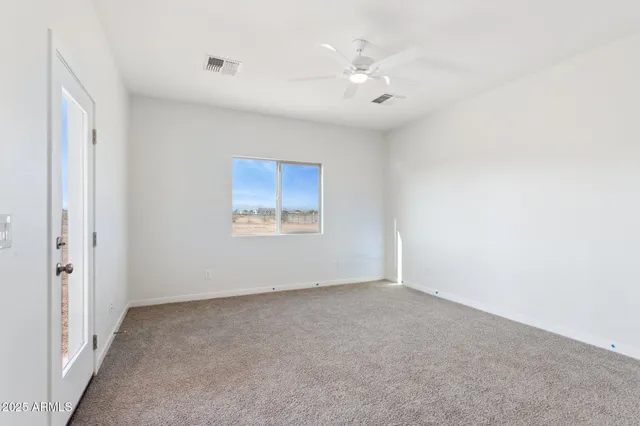a spacious bathroom with a granite countertop sink and a mirror