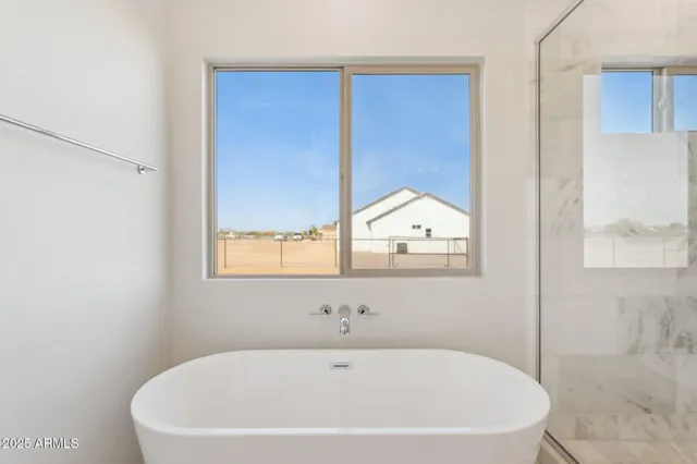 a spacious bathroom with a double vanity sink mirror and shower
