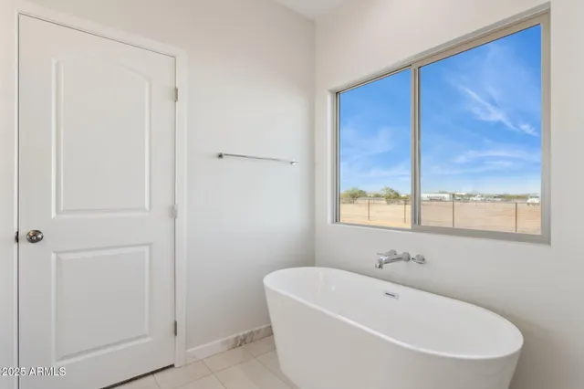 a white bath tub sitting in a bathroom