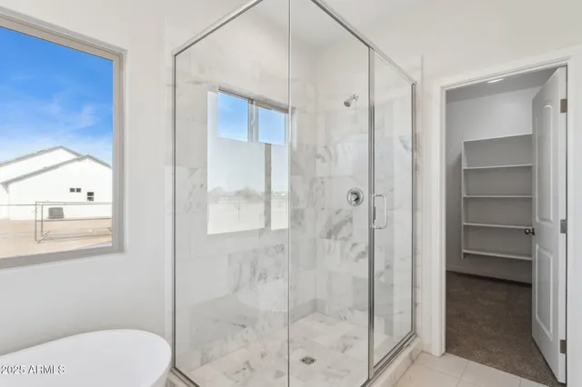 a white bath tub sitting next to a window