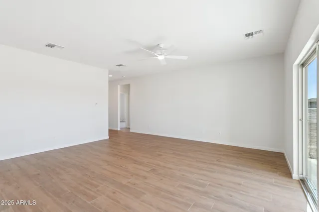 an empty room with wooden floor