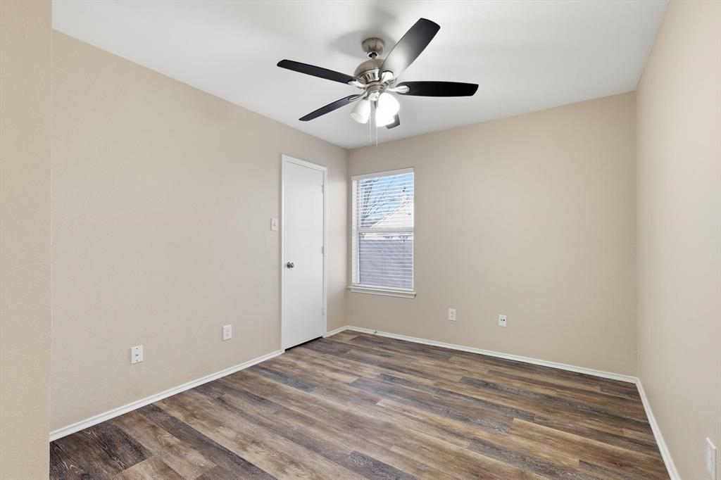 7733 Liz Lane Watauga, TX 76148 - Photo 20 of 27 Empty room with dark wood-type flooring and a ceiling fan