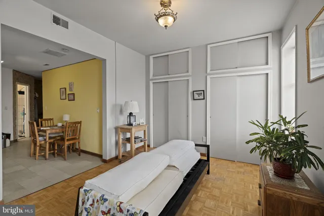 a living room with furniture potted plant and a table