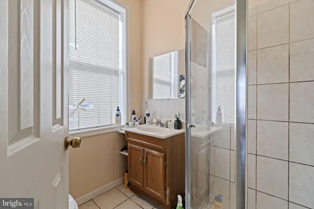 a bathroom with a sink toilet vanity and tub