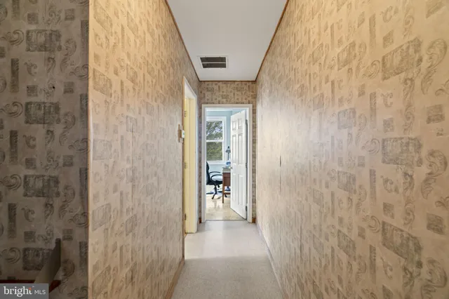 a view of a hallway with wooden shelves and entryway