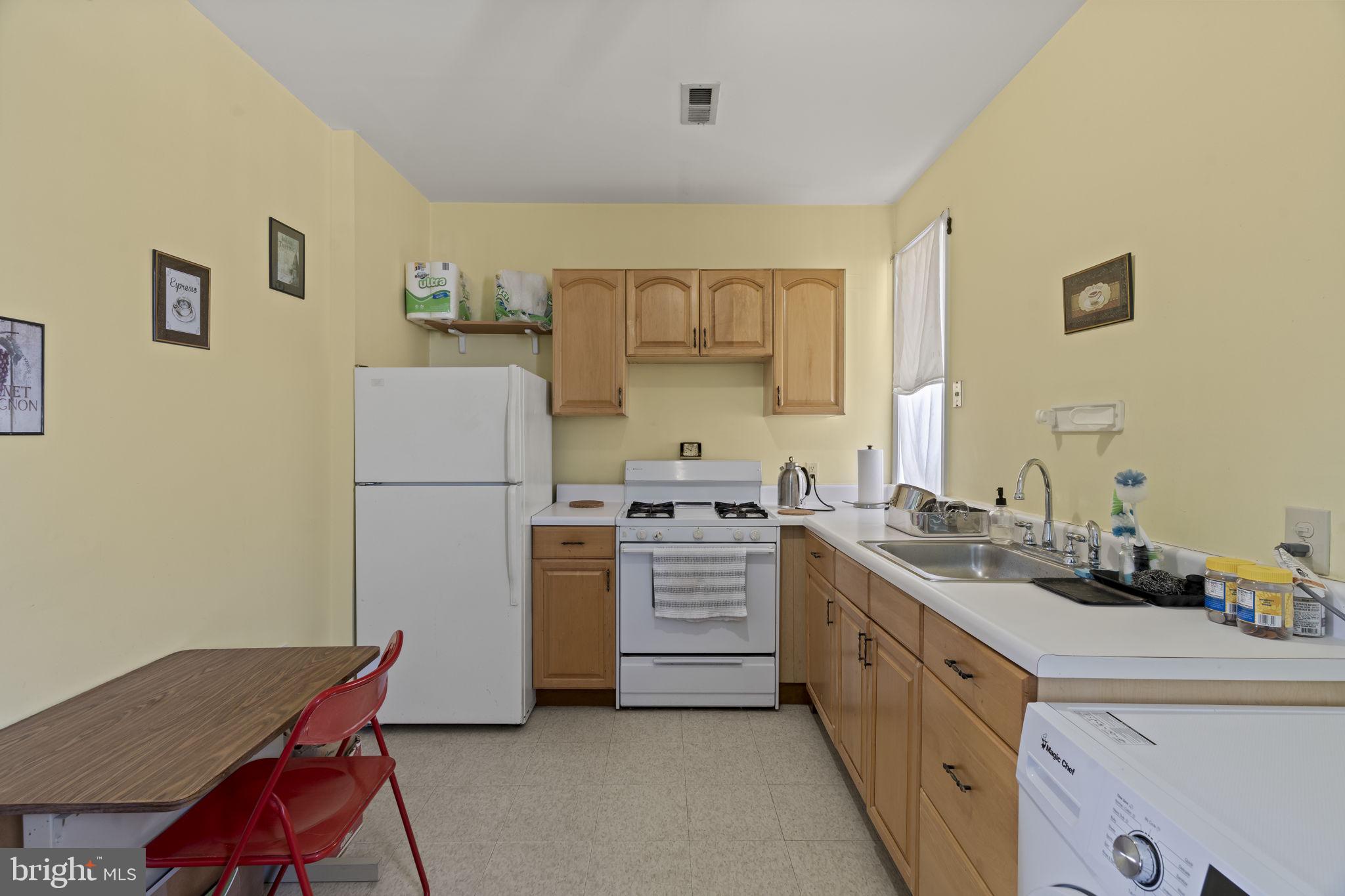 2626 East Allegheny Avenue Philadelphia, PA 19134 - Photo 21 of 32 a kitchen with a refrigerator stove and sink