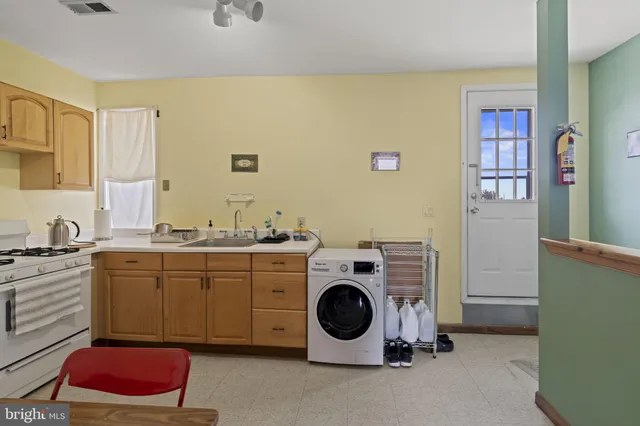 a utility room with sink dryer and washer