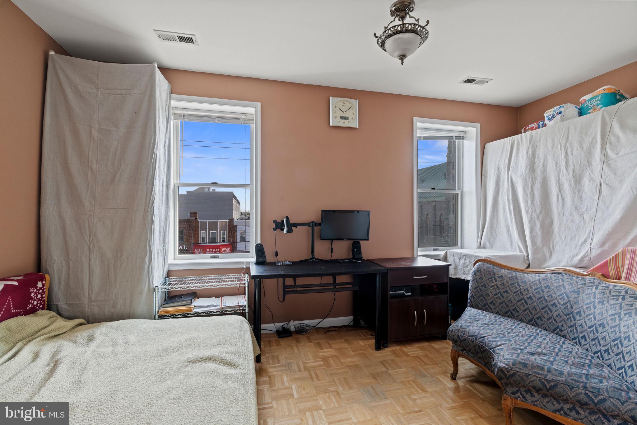 2626 East Allegheny Avenue Philadelphia, PA 19134 - Photo 25 of 32 a bedroom with furniture and a potted plant