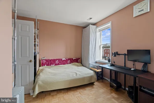 a bedroom with a bed and a window