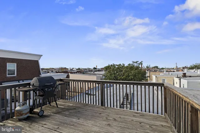 a view of a terrace with wooden floor and city view