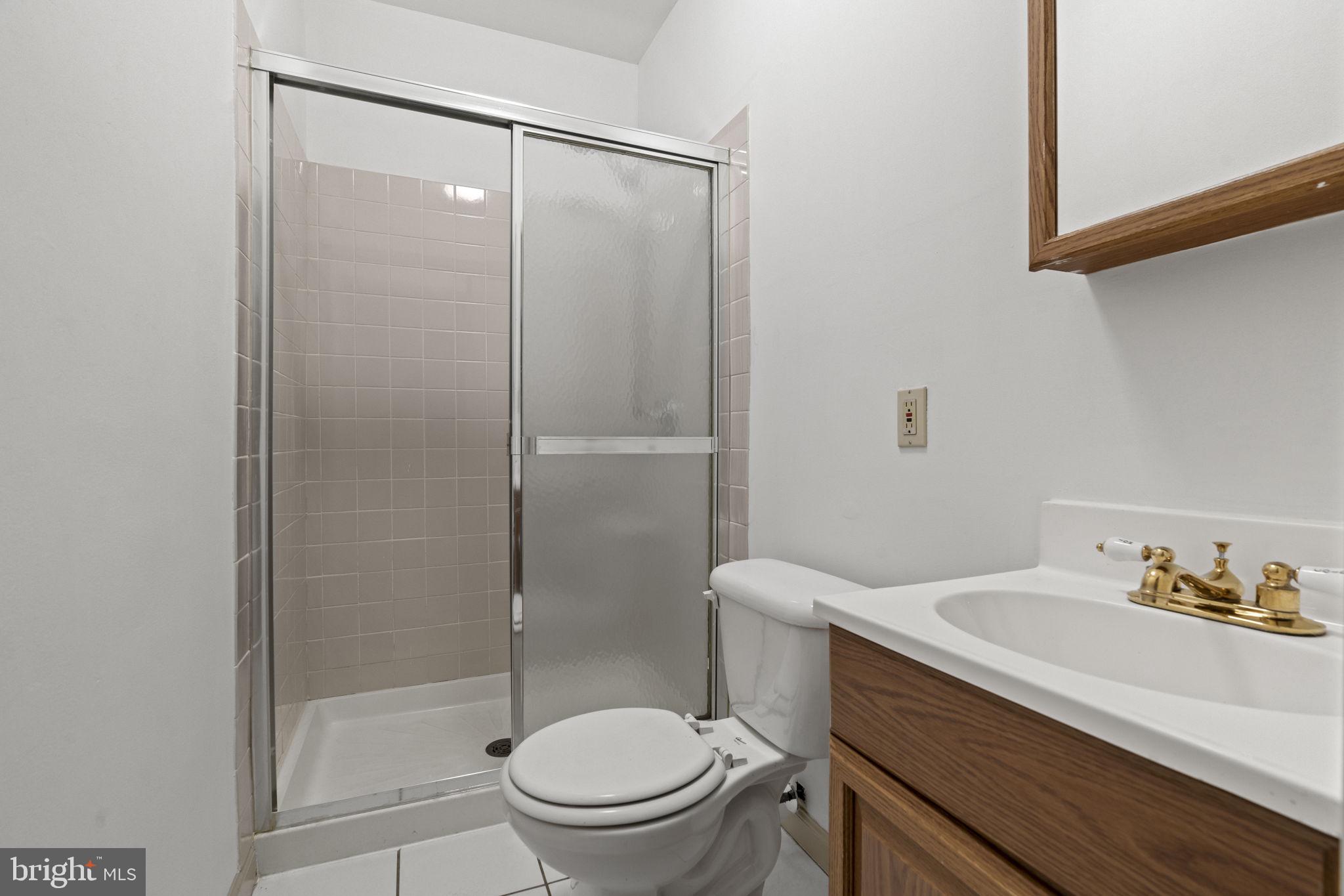 2626 East Allegheny Avenue Philadelphia, PA 19134 - Photo 8 of 32 a bathroom with a sink a toilet and shower