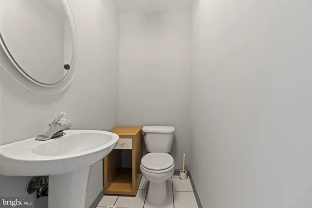 a bathroom with a toilet a sink and a mirror