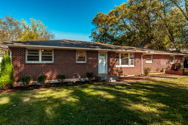 a backyard of a house with yard table and chairs