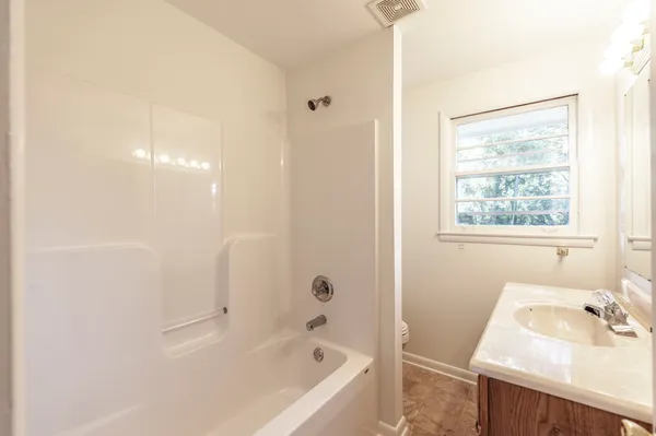 a bedroom with a large bed and a window