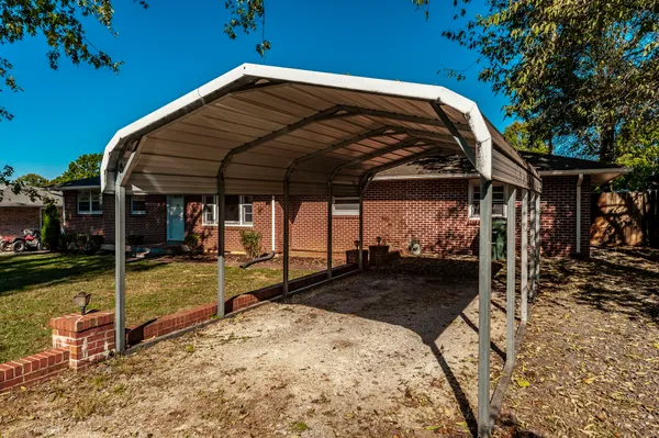 a view of a backyard with wooden fence