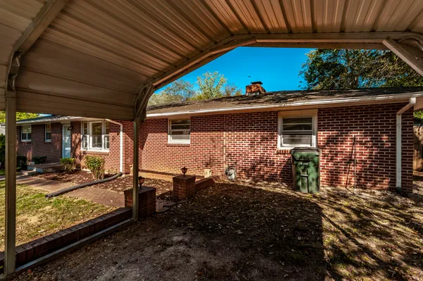 a view of a house with backyard sitting area and garden