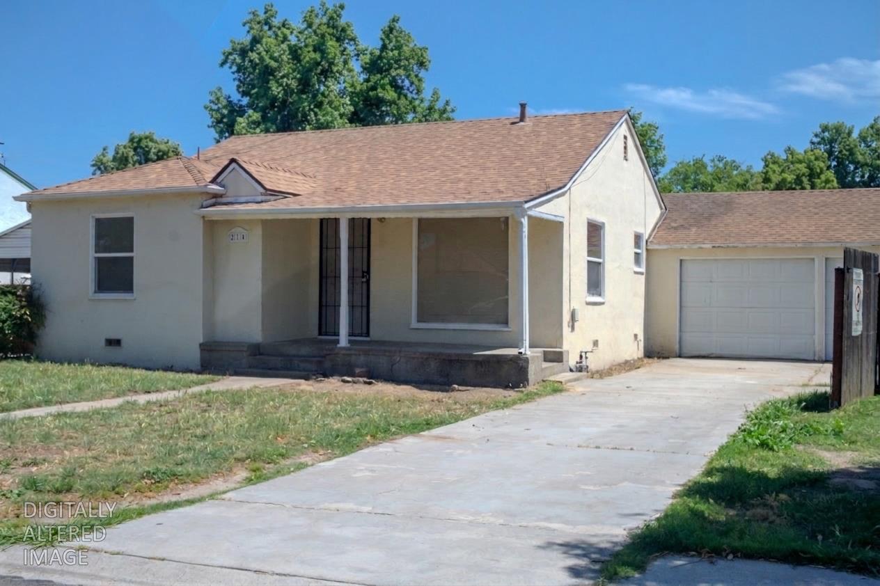 214 Ferguson Avenue Modesto, CA 95354 - Photo 2 of 14 a front view of a house with a yard and garage