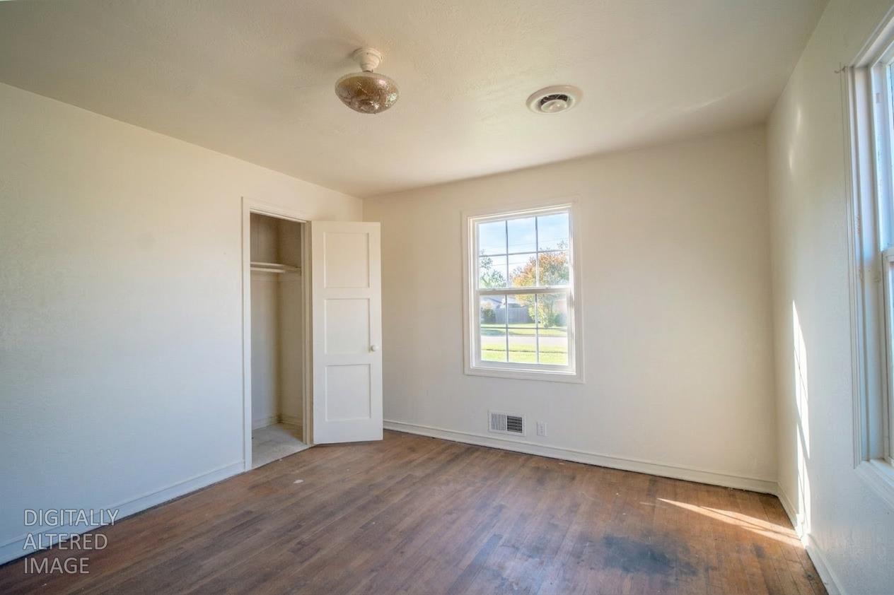 214 Ferguson Avenue Modesto, CA 95354 - Photo 10 of 14 a view of an empty room with wooden floor and a window