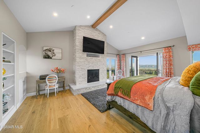 a living room with fireplace furniture and a flat screen tv