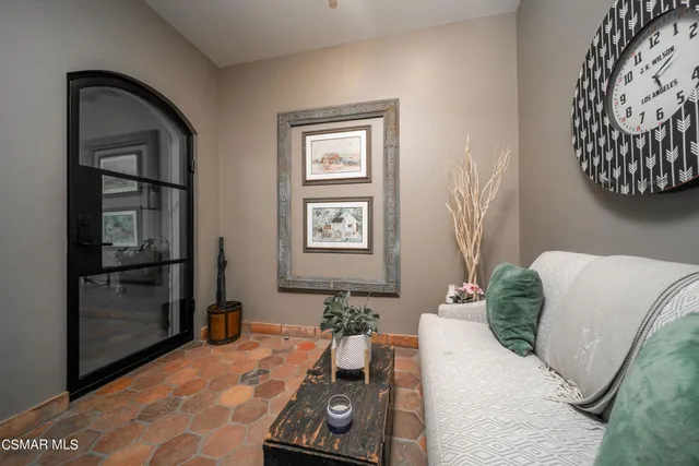 a living room with fireplace furniture and a large window