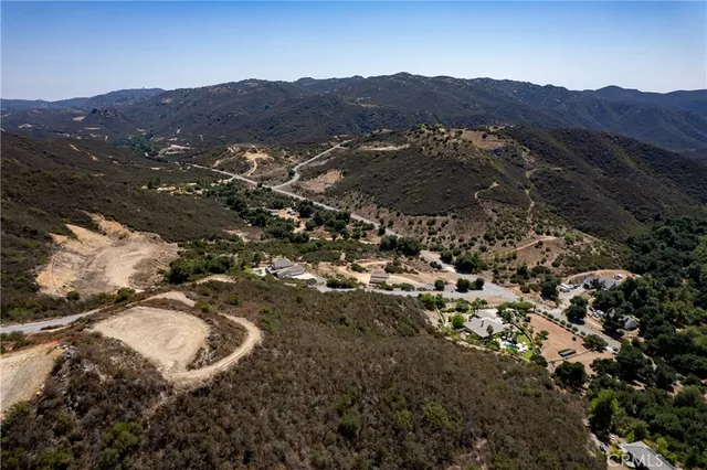 a view of a lush green hillside and houses