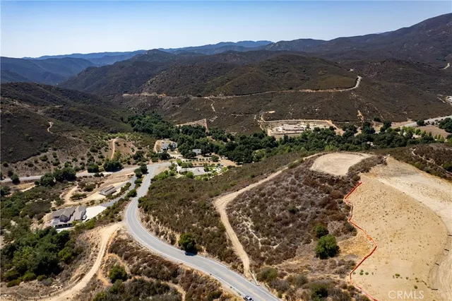 an aerial view of residential house and sandy dunes
