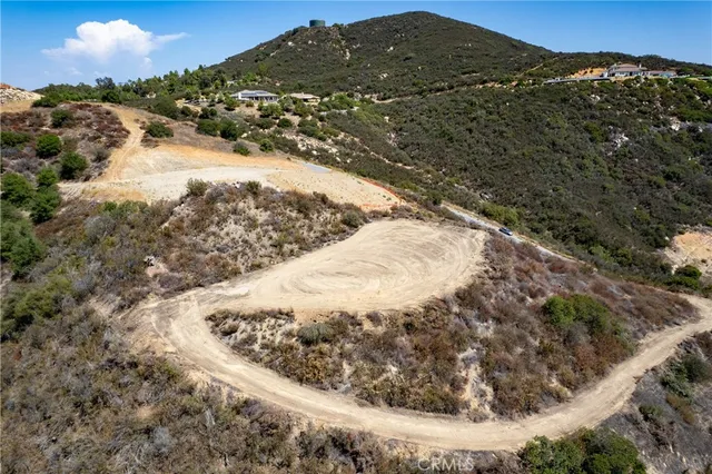 a view of a dry yard with mountains in the background