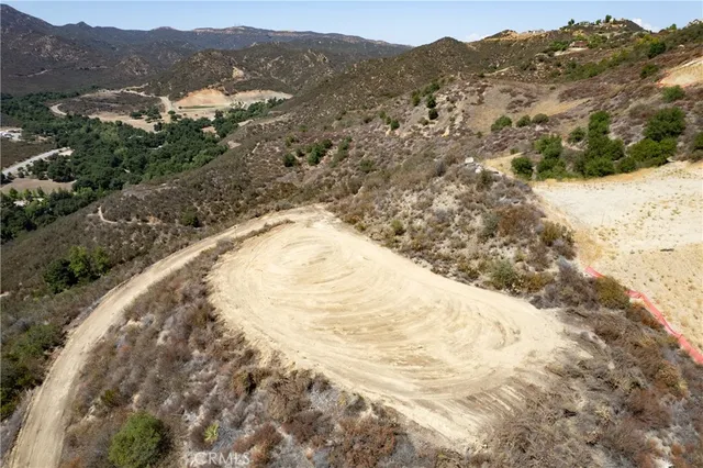 an aerial view of a house with a mountain