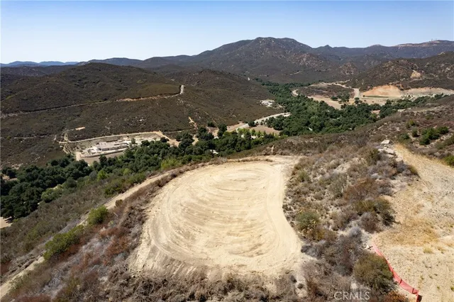 a view of a mountain with a field