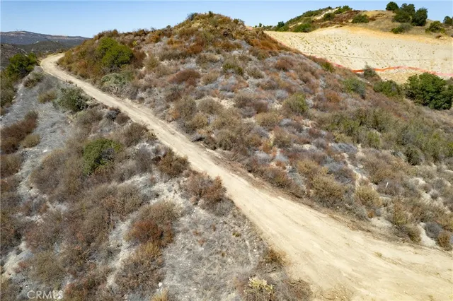 a view of a dry yard with mountains