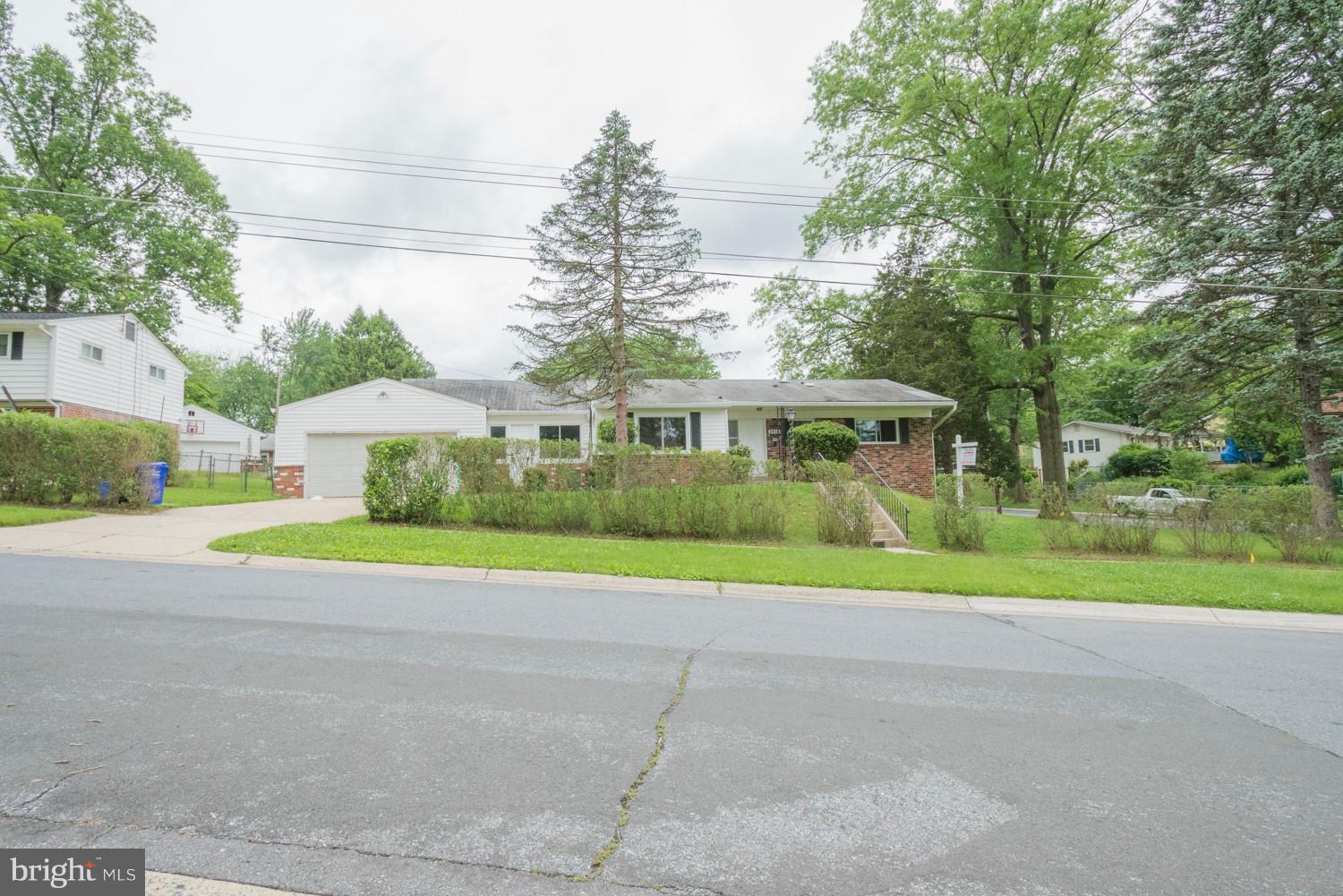 3930 Joliet Street Silver Spring, MD 20906 - Photo 2 of 28 a view of a house with a yard and large trees