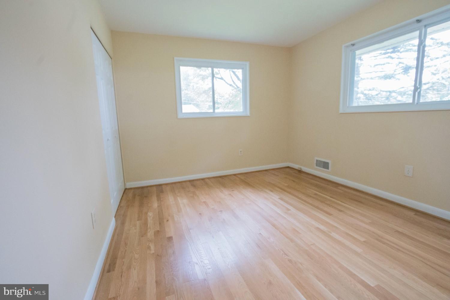 3930 Joliet Street Silver Spring, MD 20906 - Photo 13 of 28 an empty room with wooden floor and windows