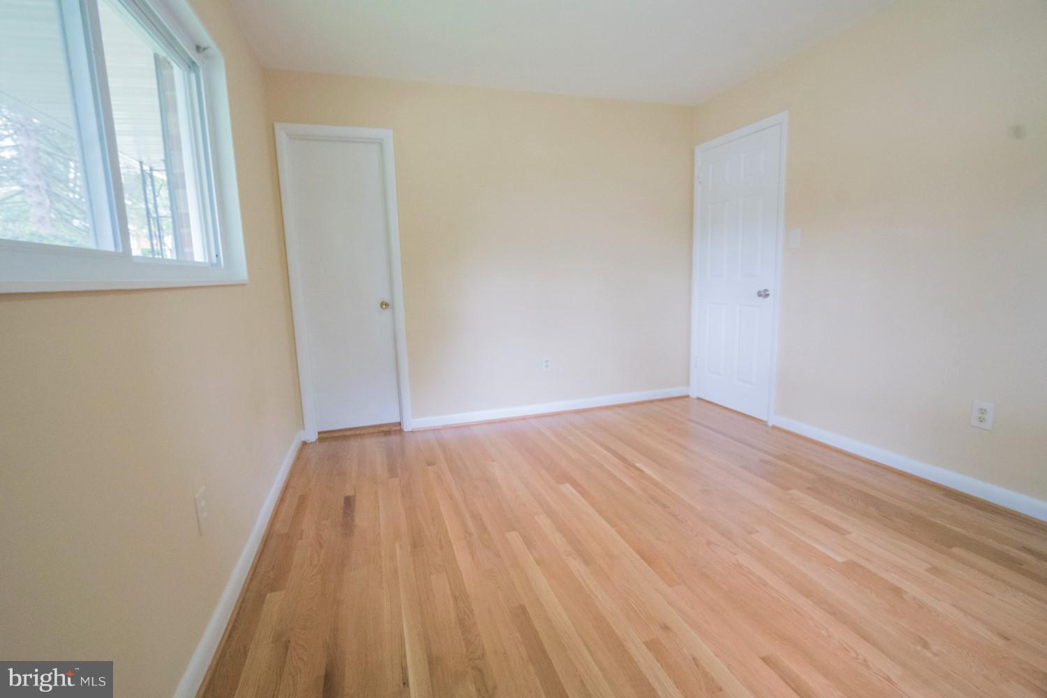 3930 Joliet Street Silver Spring, MD 20906 - Photo 14 of 28 a view of an empty room with wooden floor and a window