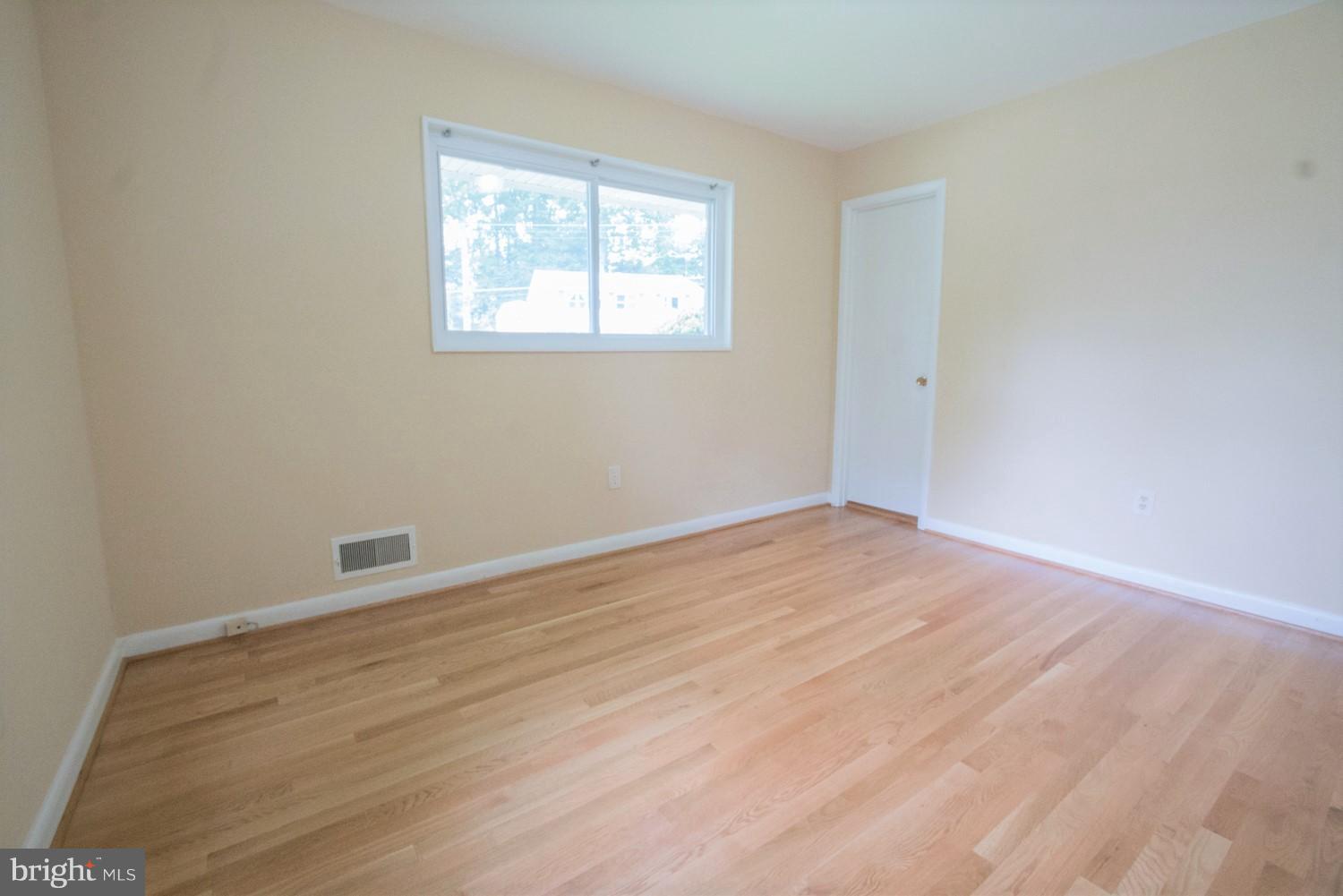 3930 Joliet Street Silver Spring, MD 20906 - Photo 15 of 28 a view of an empty room with wooden floor and a window