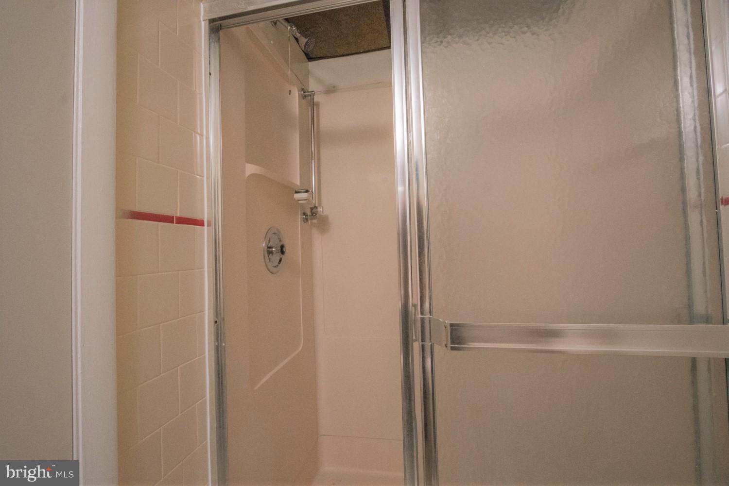 3930 Joliet Street Silver Spring, MD 20906 - Photo 25 of 28 a bathroom with a glass shower door