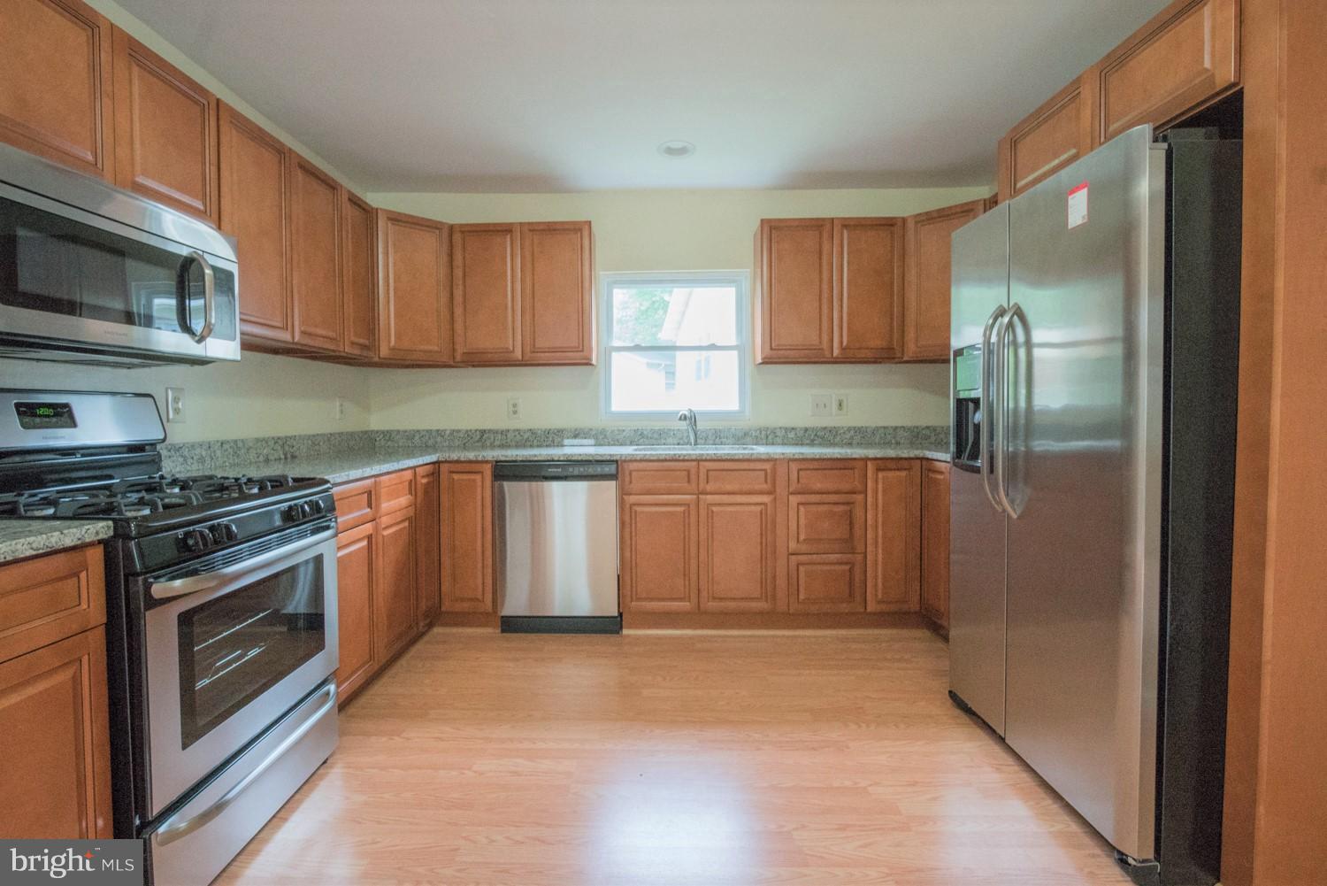 3930 Joliet Street Silver Spring, MD 20906 - Photo 4 of 28 a kitchen with stainless steel appliances granite countertop a refrigerator stove and sink