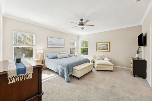 a spacious bedroom with a bed and a flat screen tv