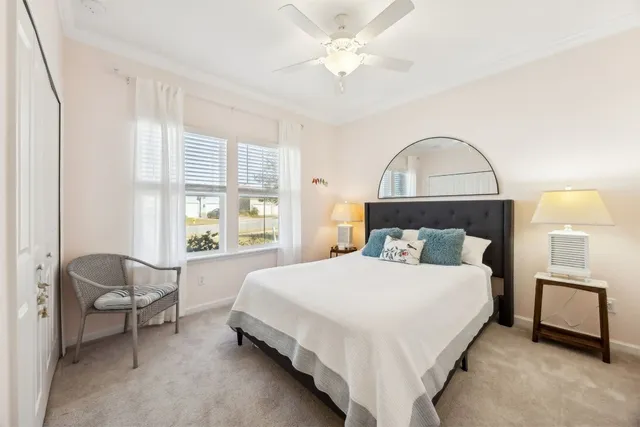 a bedroom with a bed and a lounge chair