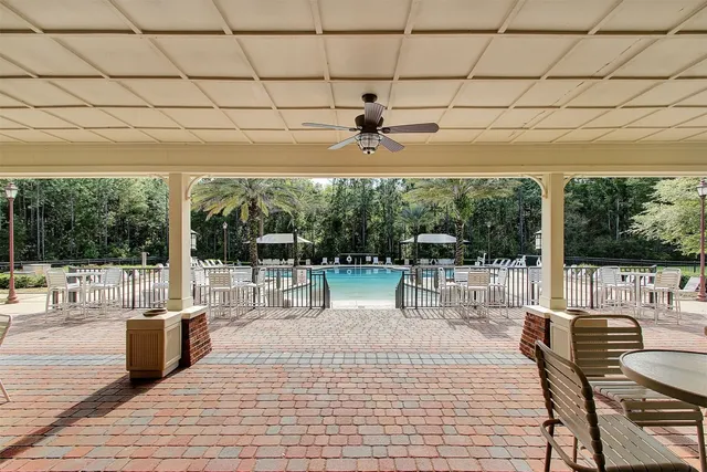 a view of a patio with dining table and chairs