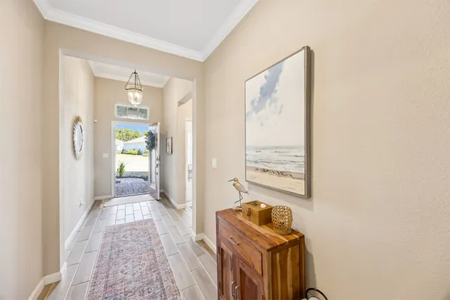a view of a hallway to a livingroom with furniture