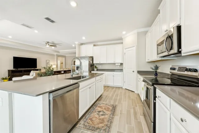 a kitchen with stainless steel appliances granite countertop a sink and a stove
